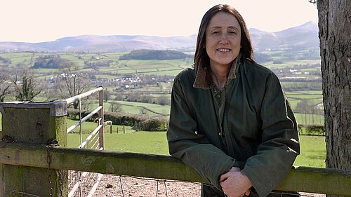 Jane Dodds MS standing in front of Green hills in Mid Wales